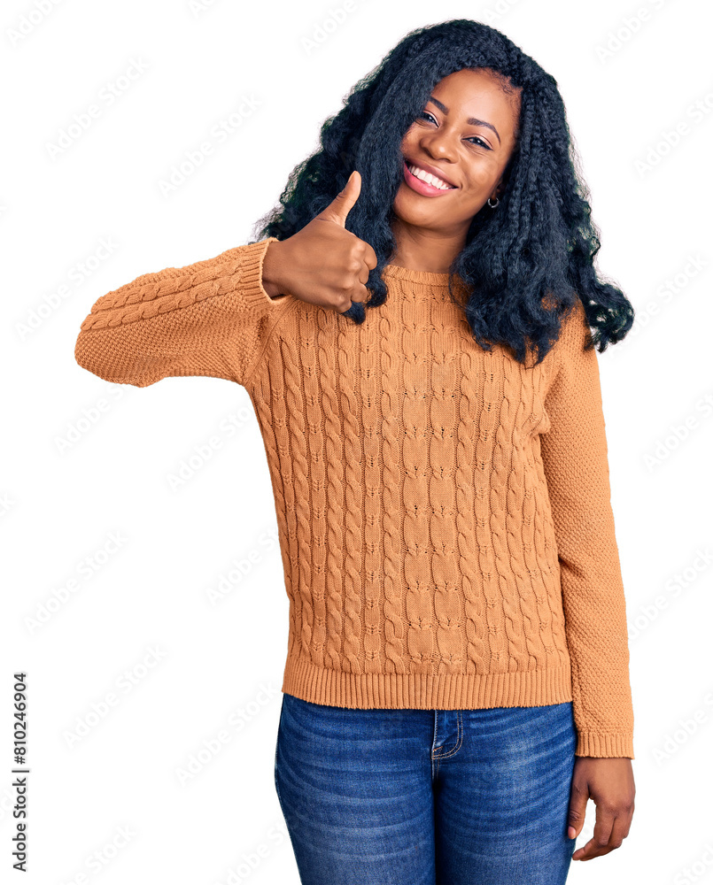 Beautiful african american woman wearing casual sweater doing happy thumbs up gesture with hand. approving expression looking at the camera showing success. Beautiful african american woman wearing casual sweater doing happy thumbs up gesture with hand. approving expression looking at the camera showing success.