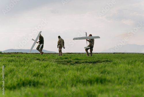 Soldiers of the modern army walk holding unmanned aerial vehicles in their hands. Soldiers on a special military operation. military operation