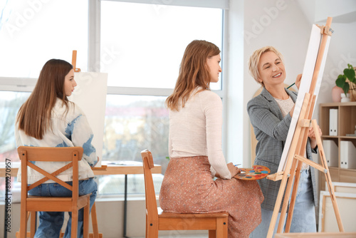 Female art teacher helping ...