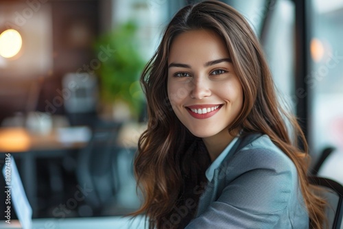 Beautiful happy businesswoman smiling at camera in office with professional business attire