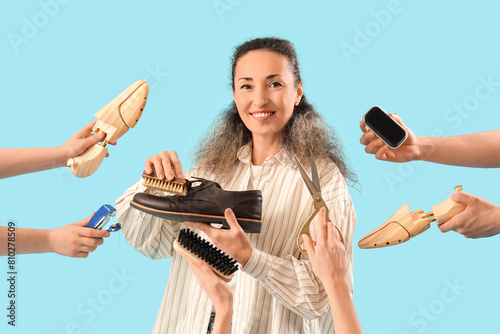 Female shoemaker and hands with tools on blue background