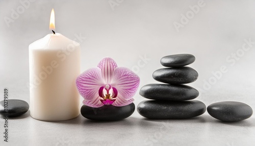 spa background with pink orchid candle and zen black stones on gray
