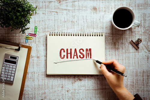 There is notebook with the word CHASM. It is as an eye-catching image. photo