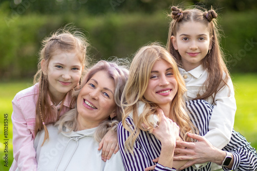 Happy family outdoors: mother, grandmother, and daughter.