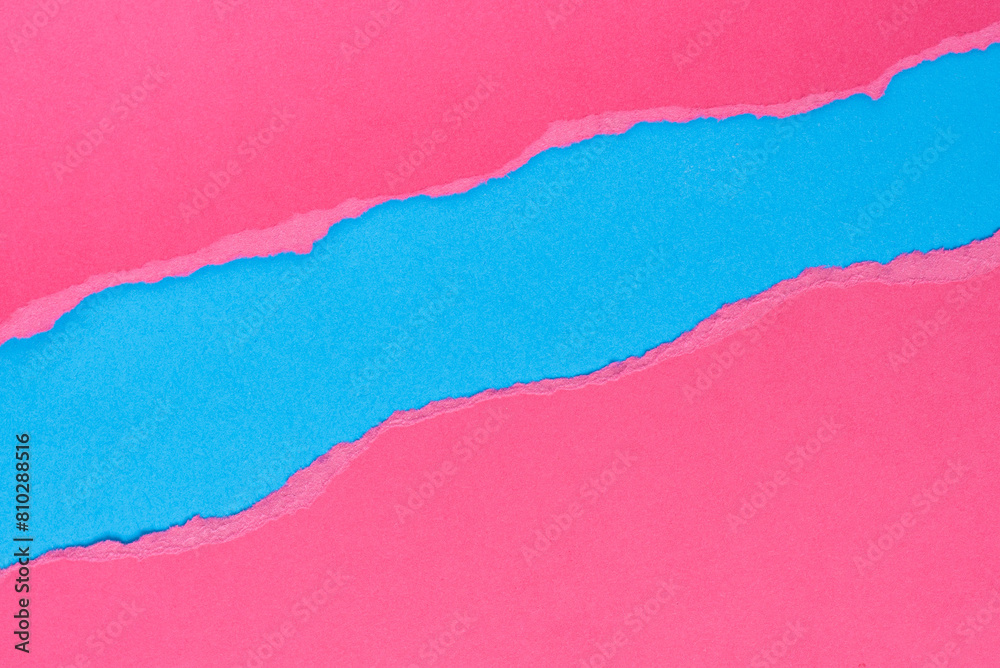 Torn pink paper on blue background. Space for text. Torn pink paper on blue background. Space for text.