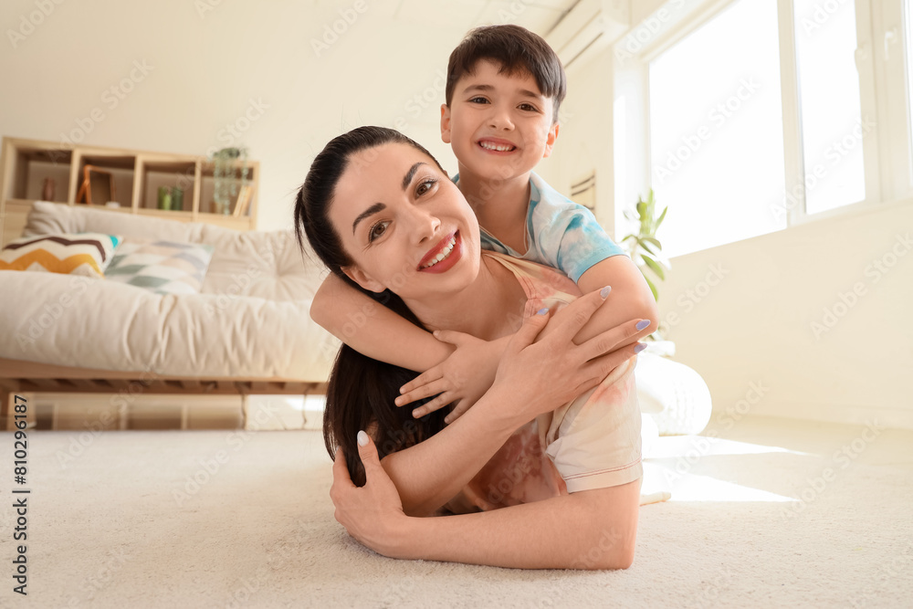 Mother with her little son hugging on floor at home Mother with her little son hugging on floor at home