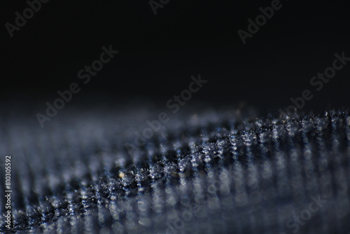 Macro of dandruff on shirt. Dandruff flakes are larger and may be yellow tinged or look oily photo