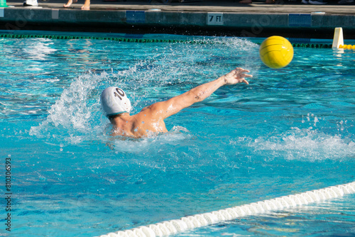 High School water polo player shooting the ball.
