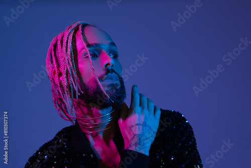 Retro wave or synth wave portrait stylish serious african-american dancer man studio shoot. High Fashion male model dance in colorful bright neon lights posing. Art design concept