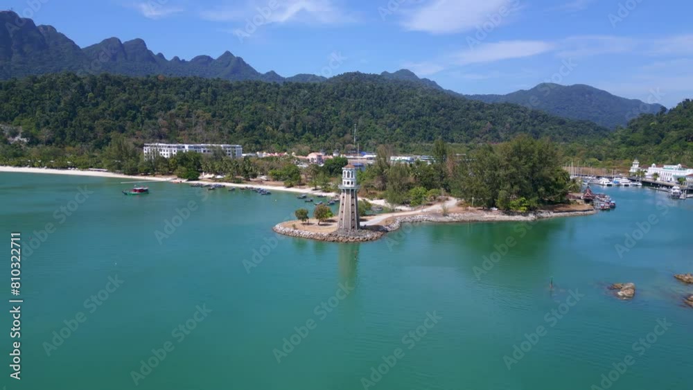 Coastal lighthouse overlooking tropical beach. Breathtaking aerial view drone Coastal lighthouse overlooking tropical beach. Breathtaking aerial view drone