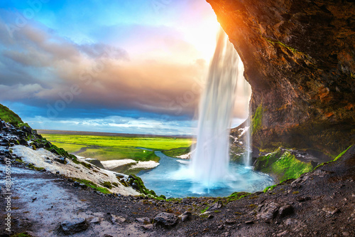 Majestic waterfall in icelandic landscape at sunset