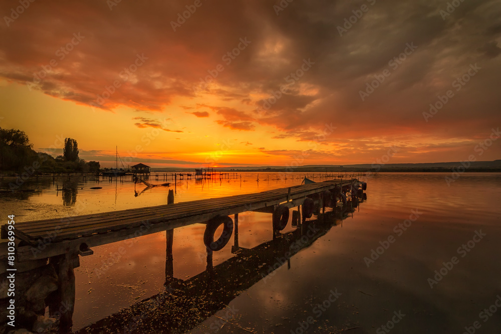 Serene lake sunset with pier