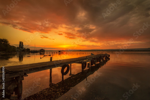 Serene lake sunset with pier