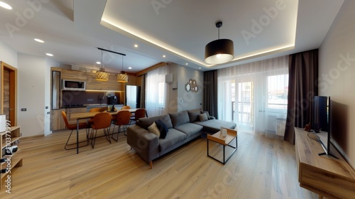 A wide-angle view of the apartment. The apartment is spacious and well-lit. The floors are made of wood, and the walls are painted white. The furniture is modern and stylish.