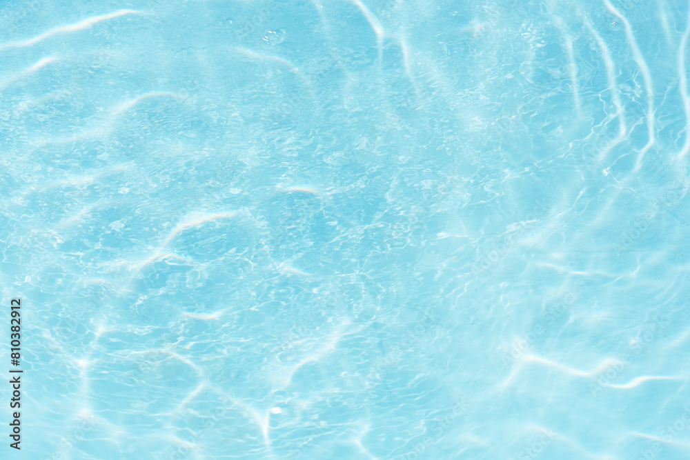 Blue water with ripples on the surface. Defocus blurred transparent blue colored clear calm water surface texture with splashes and bubbles. Water waves with shining pattern texture background. Blue water with ripples on the surface. Defocus blurred transparent blue colored clear calm water surface texture with splashes and bubbles. Water waves with shining pattern texture background.