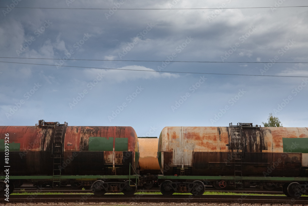 Naklejka premium Selective blur on russian train tank cars & wagons containing gas & oil imported from russia, on freight yard cargo train station of Latvia in Jelgava. Energy & oil imports from Russia have decreased.