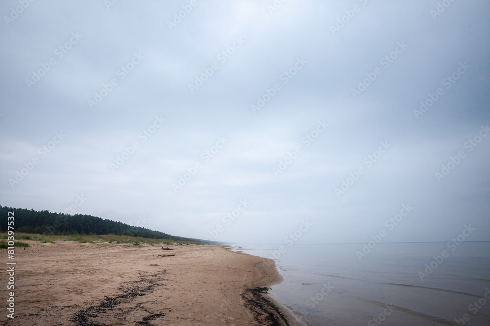 Selective blur on the Panorama of the Garciems beach (Garciema Pludmale) in Latvia, on baltic sea, on a foggy afternoon. Garciems is a sea resort in baltic states. Selective blur on the Panorama of the Garciems beach (Garciema Pludmale) in Latvia, on baltic sea, on a foggy afternoon. Garciems is a sea resort in baltic states.