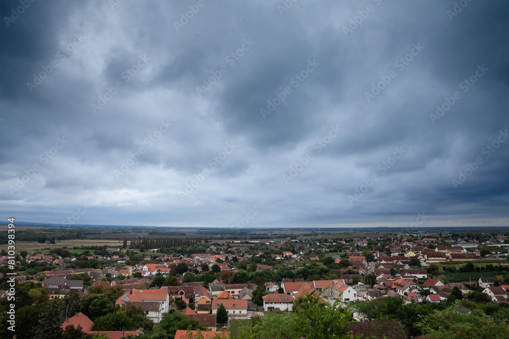 Fototapeta premium Aerial panorama of the Villany village in Baranya county in Hungary seen from the Villany Mountains at dusk. Villany Mountains, or Hegyseg, is a natural hill chain of southern Hungary.