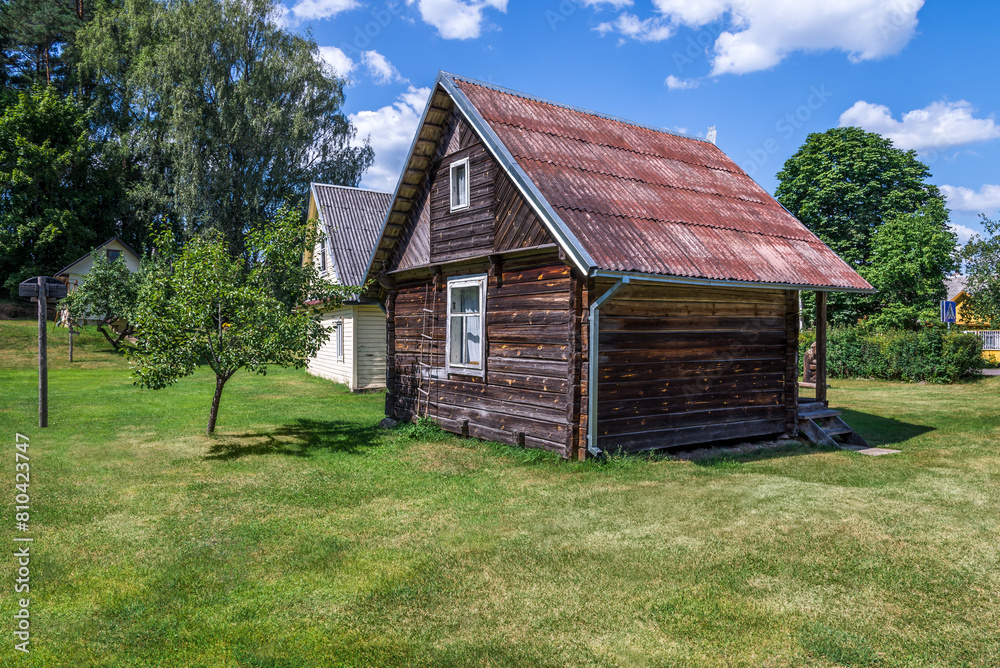 Small Rural Rustic Wooden House Standing In A Garden Lawn Small Rural Rustic Wooden House Standing In A Garden Lawn