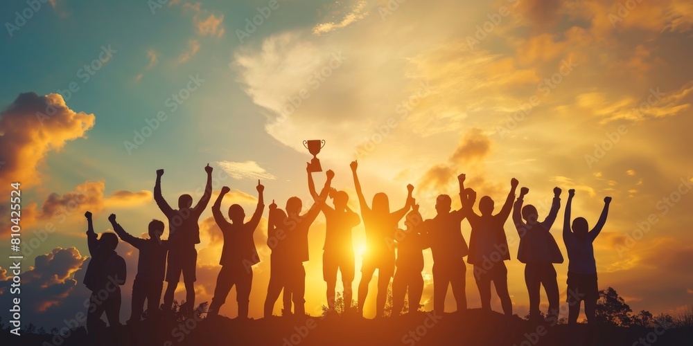 Success of teamwork. Winning team is holding trophy in hands. Silhouettes of many hands in sunset Success of teamwork. Winning team is holding trophy in hands. Silhouettes of many hands in sunset