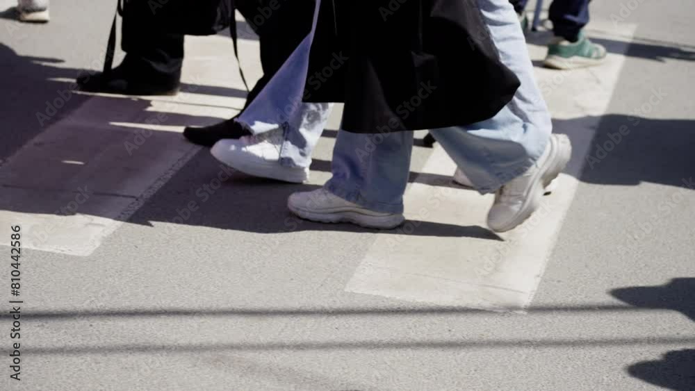 Dynamic urban scene with people walking, showcasing diverse footwear and fashionable city life on a sunny day Dynamic urban scene with people walking, showcasing diverse footwear and fashionable city life on a sunny day