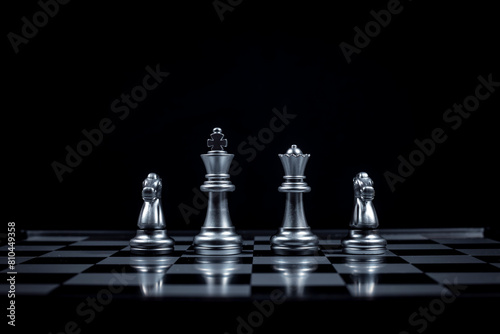 Chess board game in silver team show strategy game as business Challange competitive game  chessboard this is business strategy plan concept with black background.
