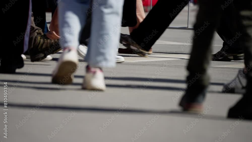Close-up of individuals' feet crossing a pedestrian zebra crossing, various footwear styles Close-up of individuals' feet crossing a pedestrian zebra crossing, various footwear styles