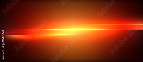 An amber and red afterglow lights up the sky as the sun sets behind the horizon, casting a warm glow on the clouds in the darkening dusk