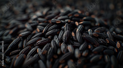 Macro shot of dense black rice grains filling the frame, highlighting the texture and natural variations in color.