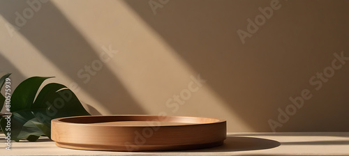 wooden round tray podium with blurry leaves shadow on green background product display background concept photo