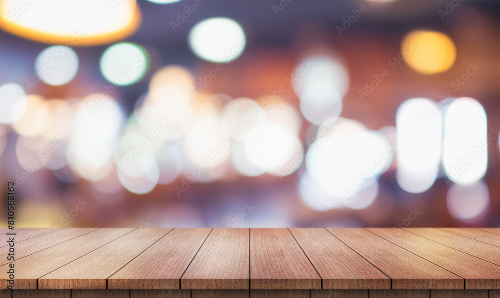 Empty wooden table top with lights bokeh on blur restaurant background. Empty wooden table top with lights bokeh on blur restaurant background.
