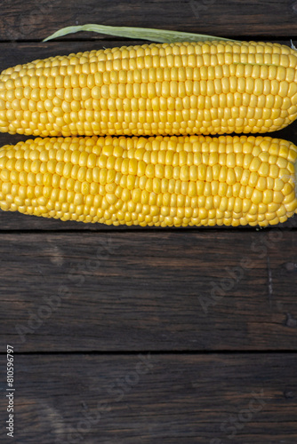 Photos Fresh corn on cobs on rustic wooden table, closeup