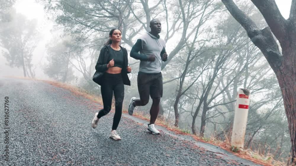 Training, running and couple with fitness, exercise and rain with wellness and healthy with nature. Endurance, outdoor and wet road with man or woman with athlete and runner with sports and cardio