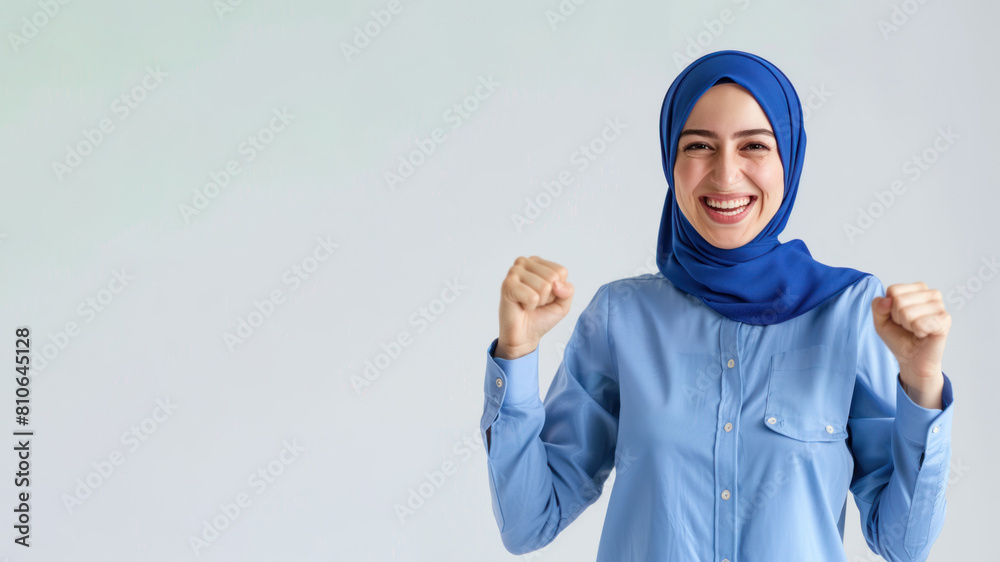 Arabian Business Woman in blue shirt has good news, smile and raised hands Arabian Business Woman in blue shirt has good news, smile and raised hands