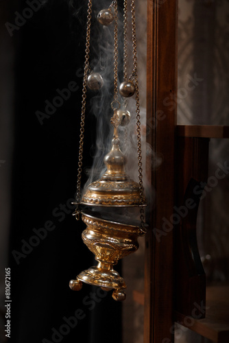 Church incense soars from a golden censer