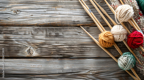 Threads with knitting needles on wooden background photo