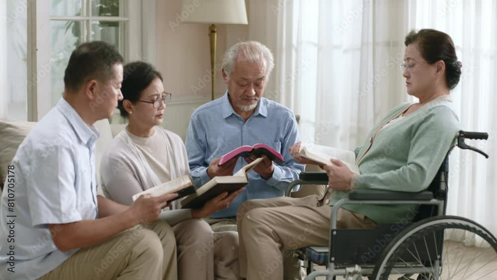 group of senior asian people sitting on couch at home reading bible together group of senior asian people sitting on couch at home reading bible together