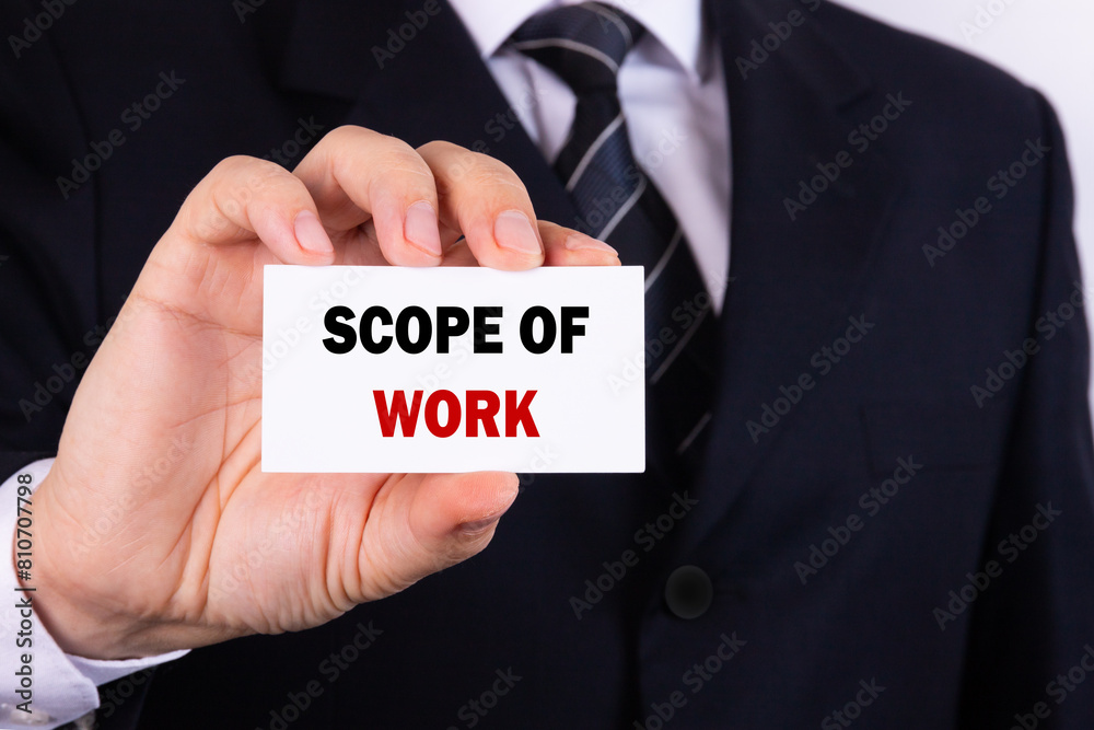 Businessman holding a card with text scope of work Businessman holding a card with text scope of work