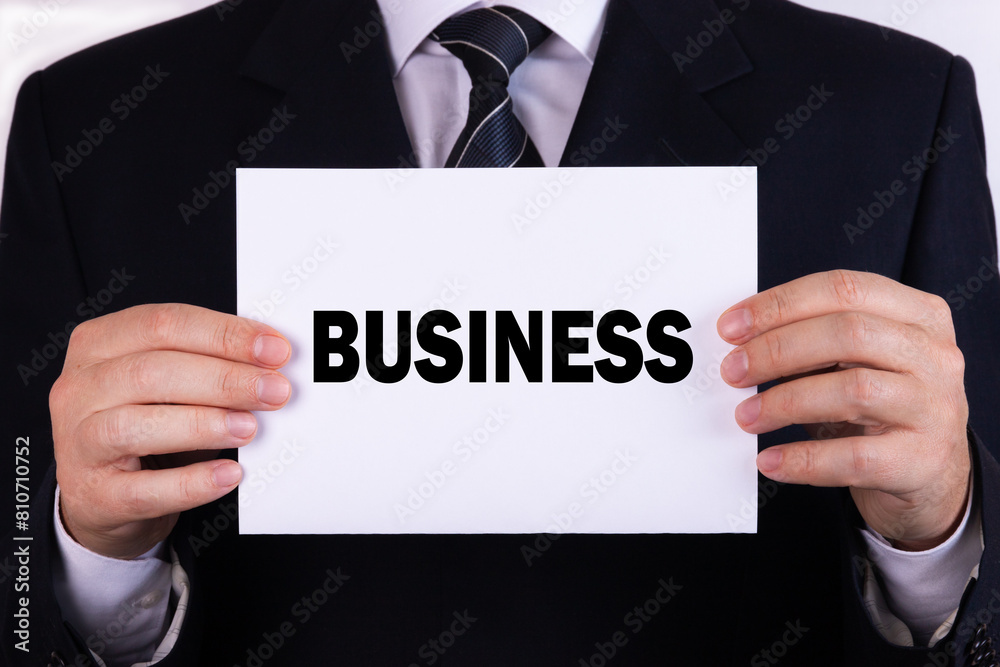 Businessman holding a card with text business Businessman holding a card with text business