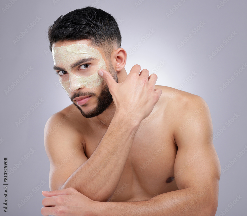 Face, mask and man with skincare in studio, portrait and grey background with dermatology. Healthy, cosmetics and model with facial in spa for detox benefits to skin with natural beauty product Face, mask and man with skincare in studio, portrait and grey background with dermatology. Healthy, cosmetics and model with facial in spa for detox benefits to skin with natural beauty product