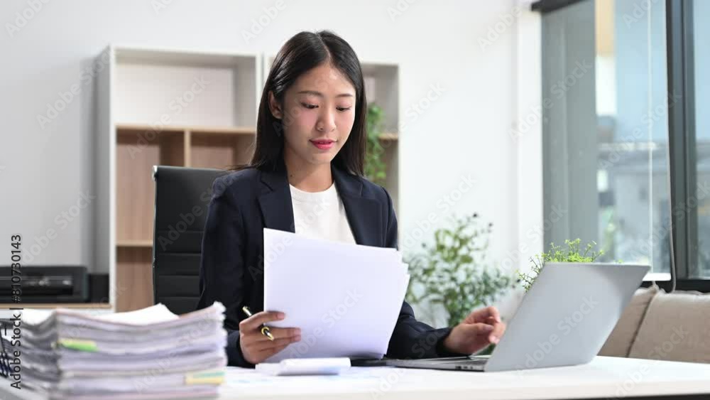 Successful Asian Businesswoman Analyzing Finance on Tablet and Laptop at modern Office Desk tax, Successful Asian Businesswoman Analyzing Finance on Tablet and Laptop at modern Office Desk tax,