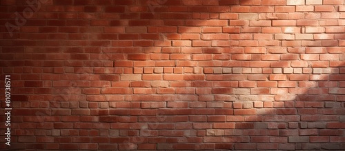 A textured red brick wall with light and shadow creating an abstract background This copy space image showcases the concept of structure and can be used as a wallpaper