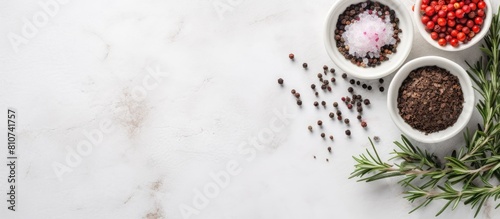 A bowl of salt thyme and peppercorns placed on a white marble table ideal for a flat lay composition The image offers ample space for adding text