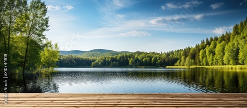 A serene forest river lake with a wooden pier set against an idyllic rural landscape on a sunny day This picturesque scene invites nature enthusiasts offering opportunities for ecotourism hiking and photo