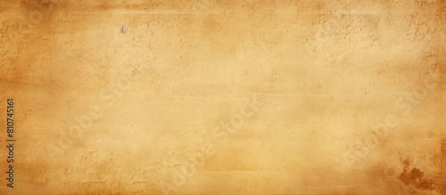 Copy space image of a beige yellow brown background with a light rough and textured paper texture featuring spotted blank areas photo