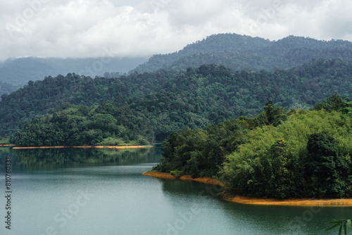 Kuala Kubu Bharu, Malaysia, features tropical trees and a green lake.