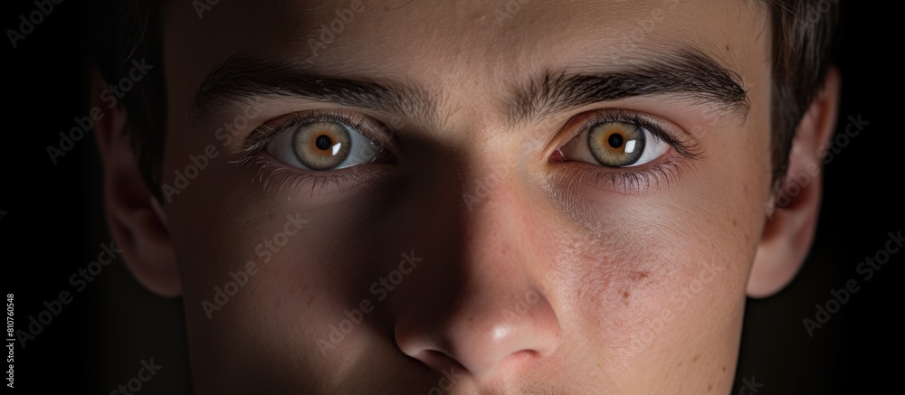 A young man s closeup portrait with a plain background behind him providing ample copy space A young man s closeup portrait with a plain background behind him providing ample copy space