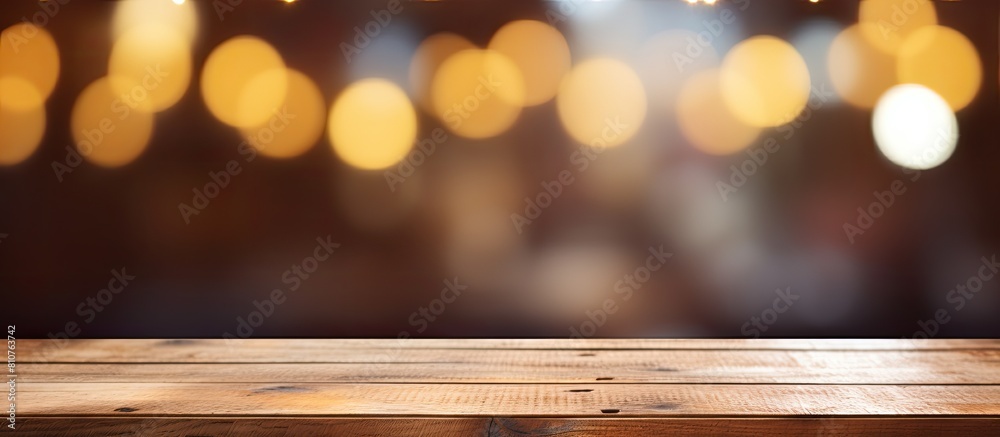 An empty wooden table with a blurred abstract background providing ample copy space for text marketing promotions