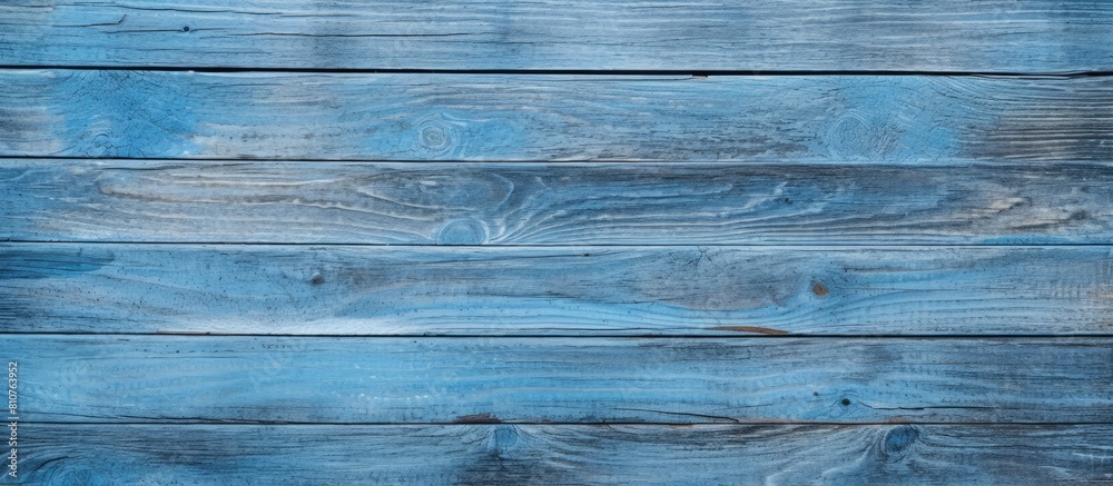 A copy space image of a wooden barn board with traces of faded blue paint creates a textured background A copy space image of a wooden barn board with traces of faded blue paint creates a textured background
