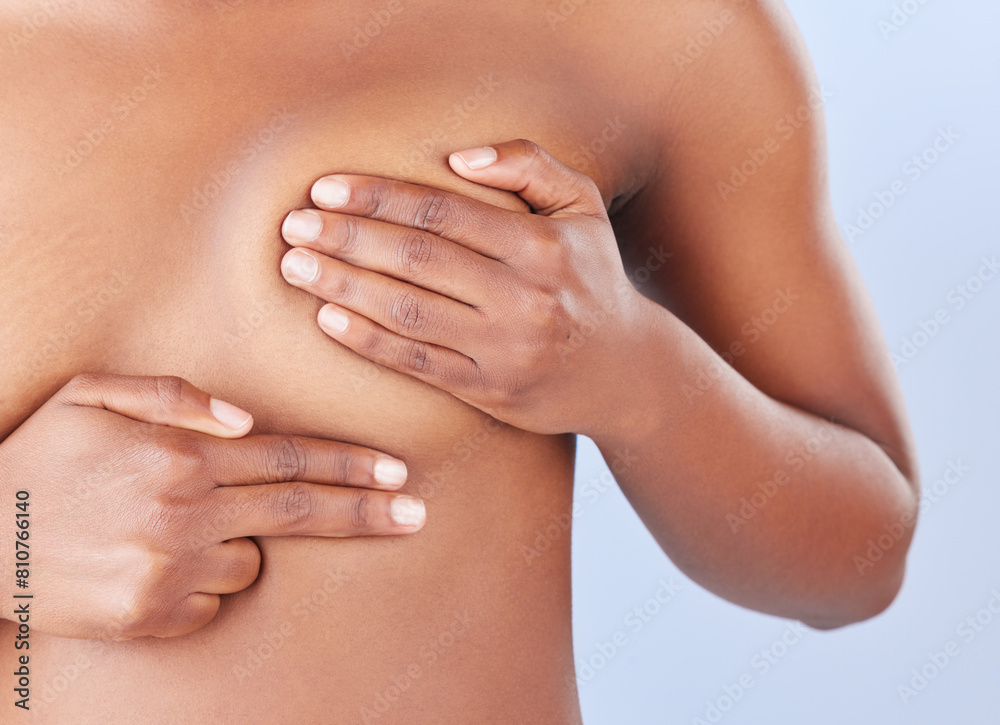 © peopleimages.com - Woman, hands and exam breast in studio, health and check for cancer in assessment on blue background. Female person, fingers and press for self diagnosis or prevention of disease, early sign and test